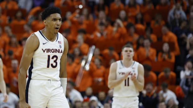 Virginia Cavaliers guard Ryan Dunn (13) reacts against the Virginia Tech Hokies in the second half at John Paul Jones Arena.
